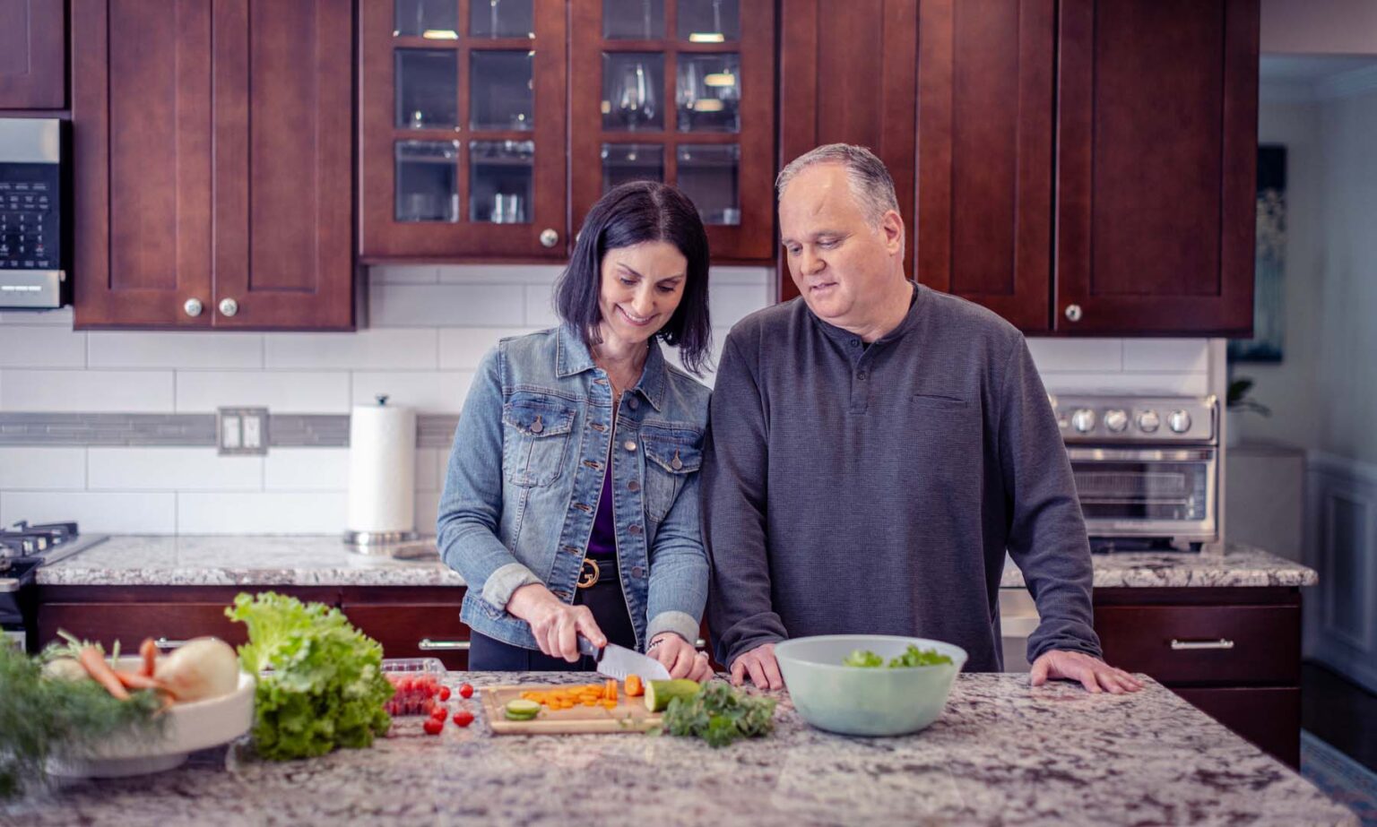 Alexis and her husband cooking together in kitchen.