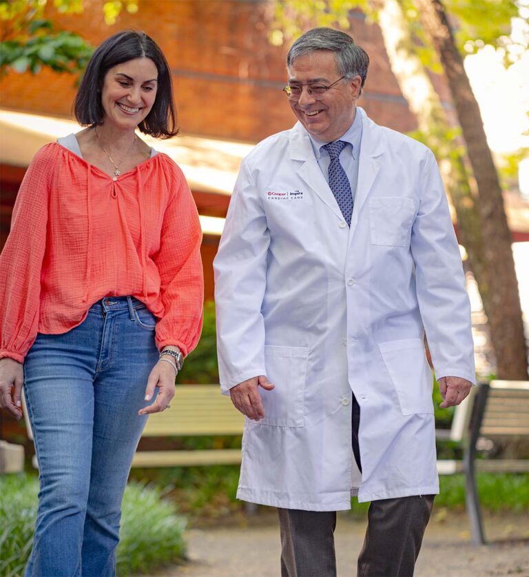 Dr. Ginsberg and Alexis walking and smiling in park.