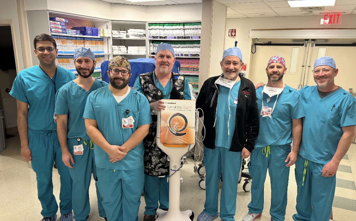 Several doctors on the Cooper and Inspira Cardiac Care team show off the Symplicity™ surgical device.