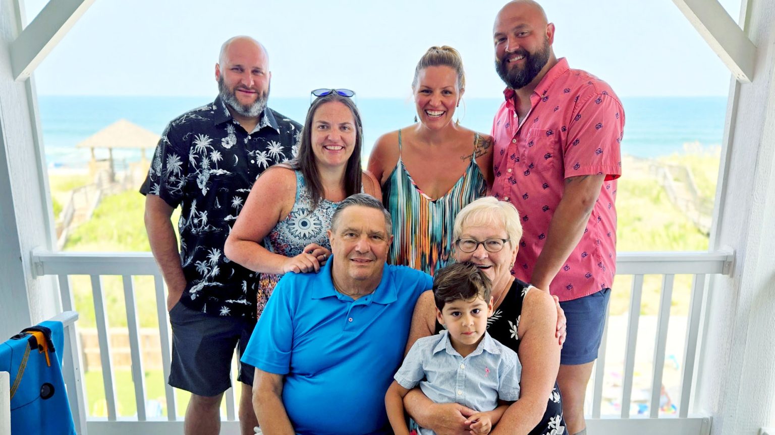 Vince and his family with ocean backdrop.