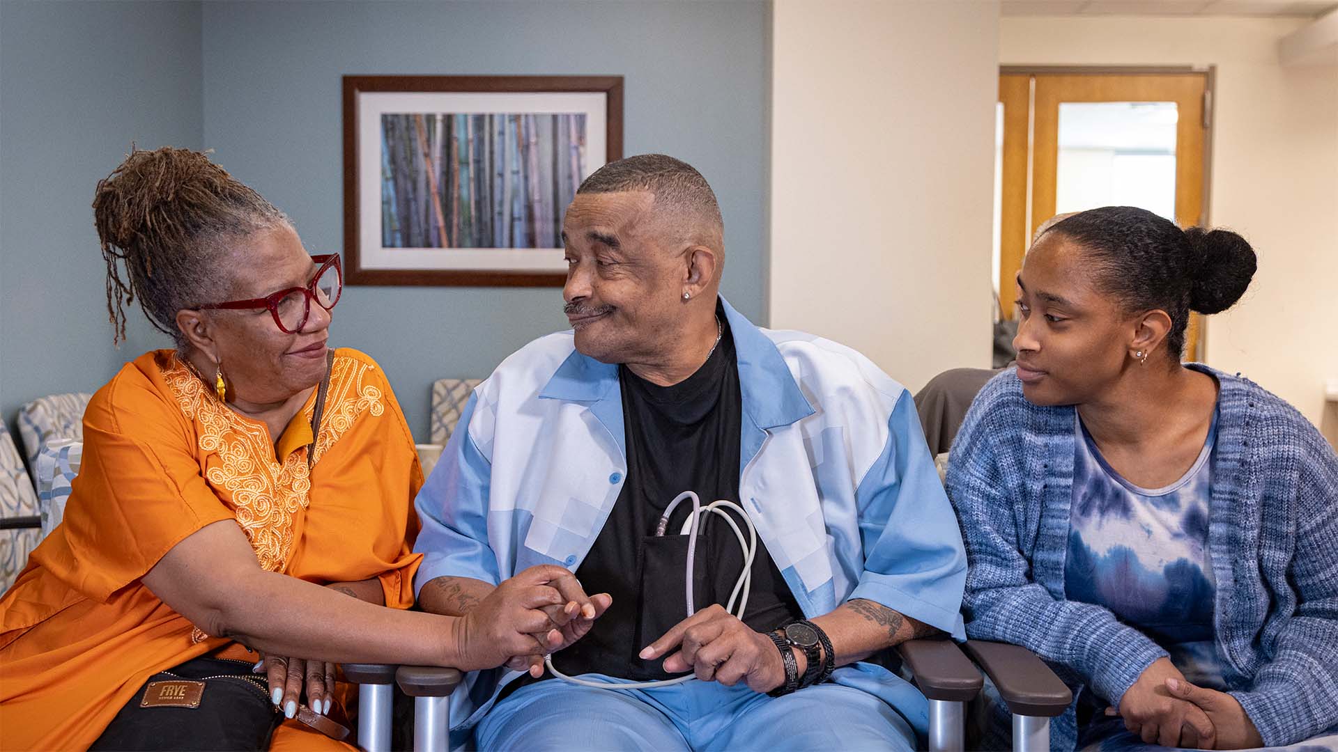 Ward, with his wife and daughter, share a warm moment of connection while sitting at the hospital waiting room.